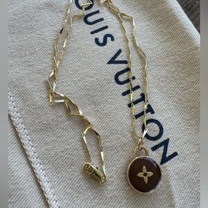 Chocolate brown with gold tone LV skittle cross charm with gf 18 inch necklace.